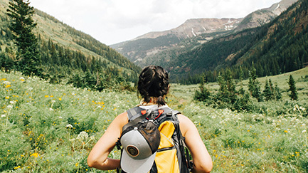 A woman on a nature hike in the mountains.