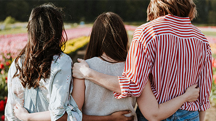 3 women standing together.