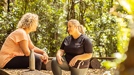 Two women in nature having a conversation.