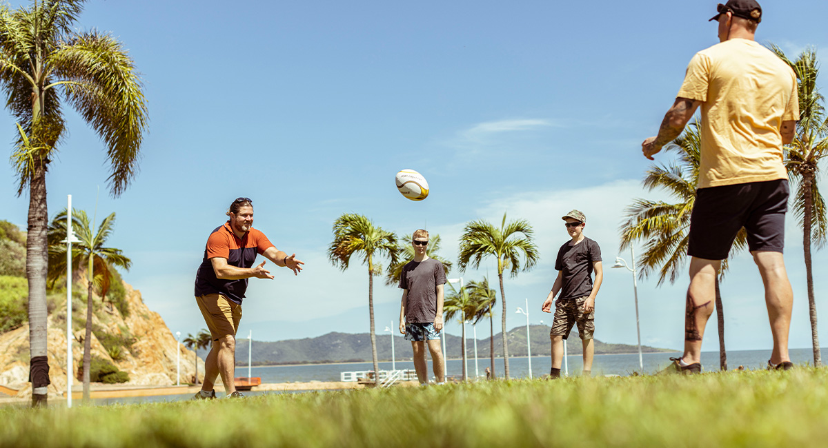 Group of people playing with a rugby ball in the park