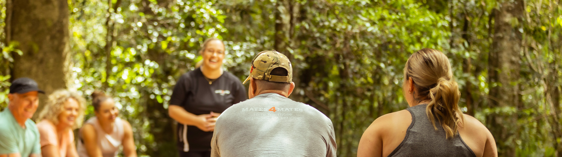 A group sitting in an outdoor activity lead by a Mates4Mates staff member.
