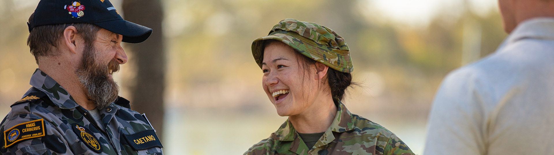 Navy and Army personnel talking and laughing together