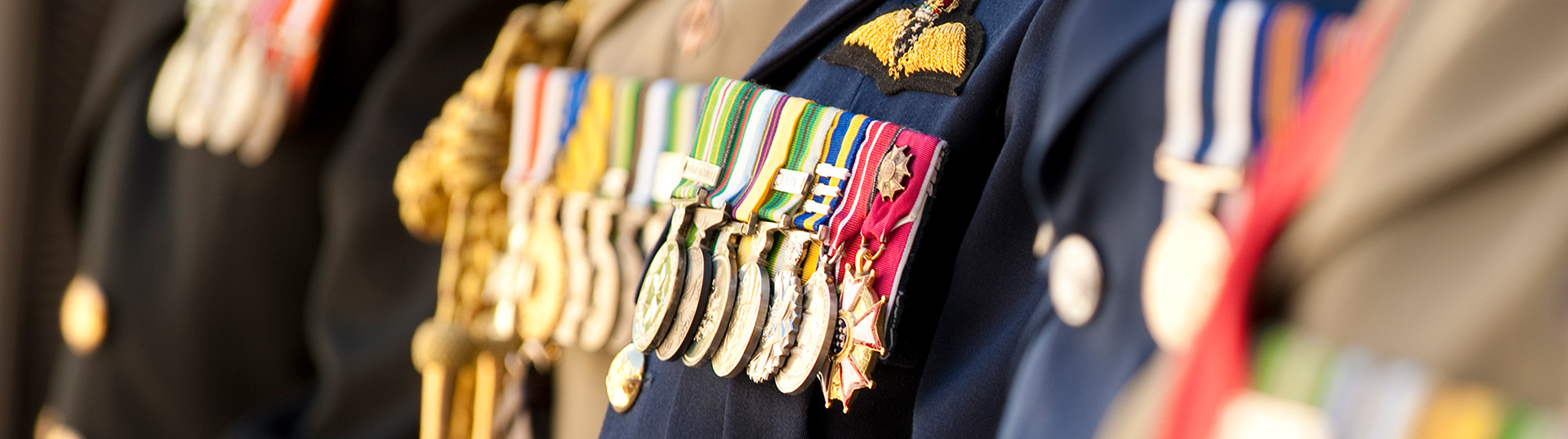 People dressed in uniform displaying their medals.