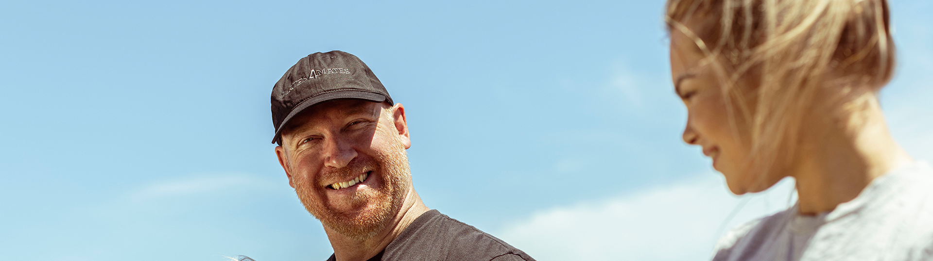 Veteran family sitting together outdoors.