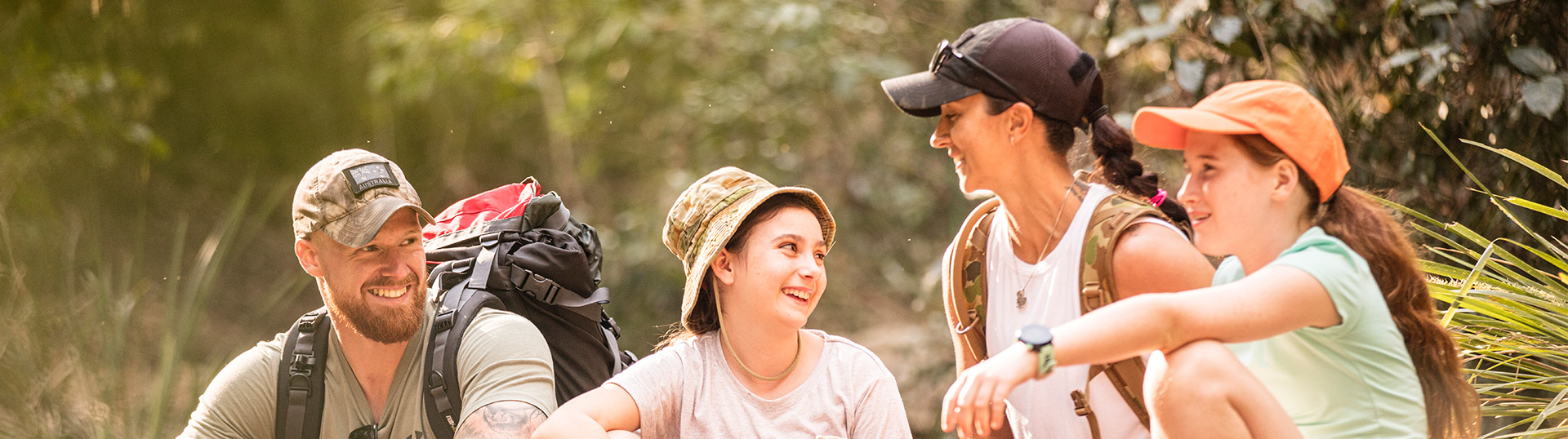 Veteran family sitting together, taking a break from an outdoor activity.