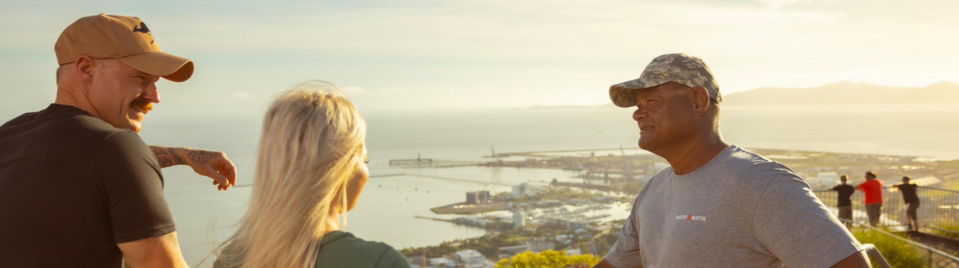 Group standing together at a look out, talking together.