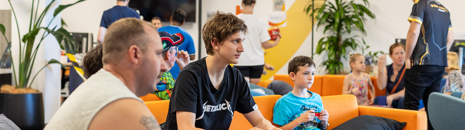 Veteran families playing video games on couches at the RSL Queensland Veteran & Family Wellbeing Centre in Brisbane
