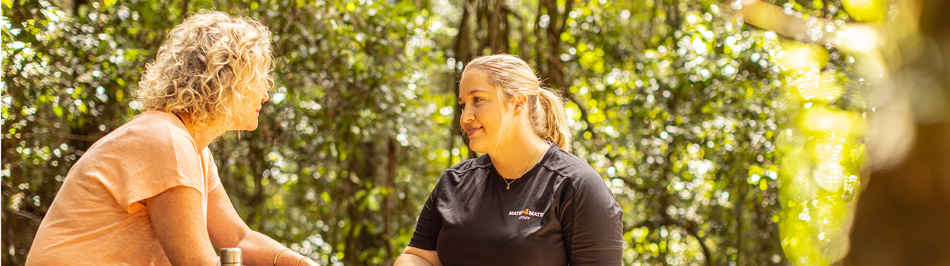 Two women in nature having a conversation.