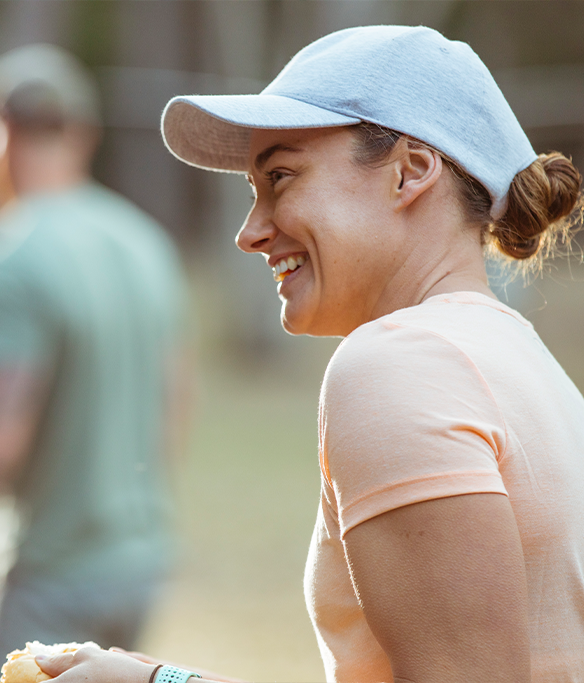 Woman wearing a cap smiling to a group